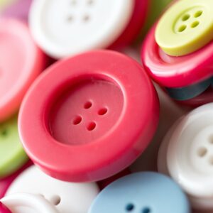 close up of sewing buttons